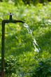 water crane in garden with flowing water water crane in garden with flowing water