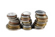 Three stacks of different coins on white background Three stacks of different coins on white background