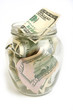 Dollar bills in glass jar Dollar bills in glass jar