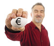 Mature man holds an egg with Euro currency symbol (€) on it. Mature man holds an egg with Euro currency symbol (€) on it.