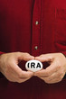 IRA on white nest egg held by man IRA on white nest egg held by man