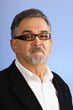 Serious mature businessman with glasses against blue Serious mature businessman with glasses against blue