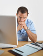 Man at Computer worries about money and bankruptcy