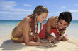 couple discover a small crab on lanikai beach