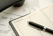 Phone with capped black pen on planner