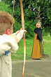 archer pointing bow at women with the apple on the head archer pointing bow at women with the apple on the head