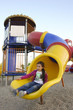 Girl slides in playground - Blurred girl give dynamic effect