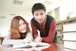 asian boy and girl studying in library