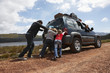 Family pushing a car