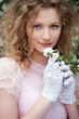 beautiful young woman in white gloves with flowers