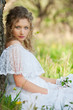woman in white dress sitting on grass