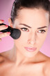 pretty woman applying cosmetic powder brush pretty woman applying cosmetic powder brush