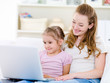 Mother with daughter looking at laptop