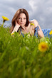 Beautiful woman lying on the grass in the summer park