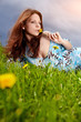 Beautiful woman lying on the grass in the summer park