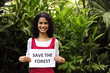 Photo: environment conservation: woman holding a save the forest sign environment conservation: woman holding a save the forest sign