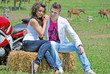 Photo: couple on a hay bale couple on a hay bale