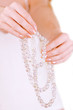 girl holding white pearl beads