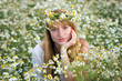 beautiful girl in a camomile field
