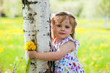 little smiling girl near birch