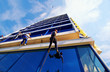 Photo: Workers washing windows in the office building Workers washing windows in the office building