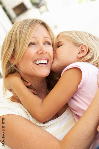 Photo: Daughter Giving Mother Kiss Relaxing On Sofa Daughter Giving Mother Kiss Relaxing On Sofa