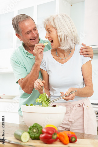 Photo: Senior Couple Preparing Salad In Modern Kitchen Senior Couple Preparing Salad In Modern Kitchen