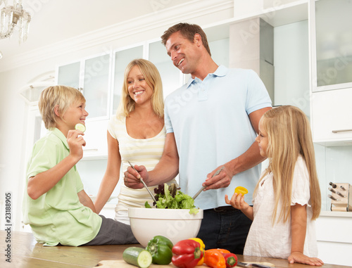 Photo: Family Preparing Salad In Modern Kitchen Family Preparing Salad In Modern Kitchen