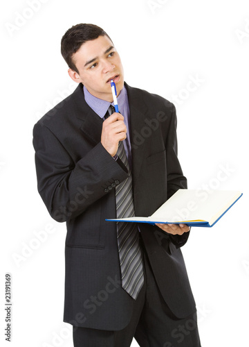 Photo: Young man holding book isolated on white background Young man holding book isolated on white background