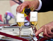 Foto: Wedding - Pouring Champagne to Groom and Bride Glasses Wedding - Pouring Champagne to Groom and Bride Glasses