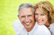 Close-up portrait of a mature couple smiling and embracing.