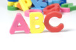 multicoloured bright plastic letters ABC on white background