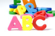 multicoloured bright plastic letters ABC on white background
