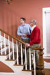 Foto: Man helping senior father climb stairs at home Man helping senior father climb stairs at home