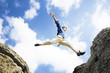 Photo: Businessman jumping over the mountains, business concept Businessman jumping over the mountains, business concept