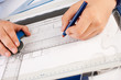 Architect working on architectural plans in the office