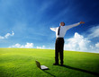 happy young businessman on spring field