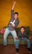 Man Playing Video Game with Bored Young Boy