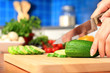 Female chopping food ingredients.