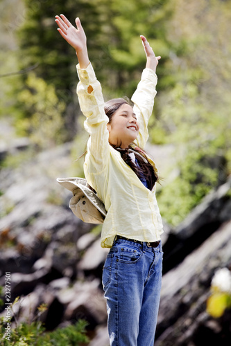 Photo: Girl raising hands in praise Girl raising hands in praise