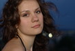 a girl with brown hair fluttering in the wind