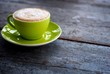 Green cup of cappuccino
