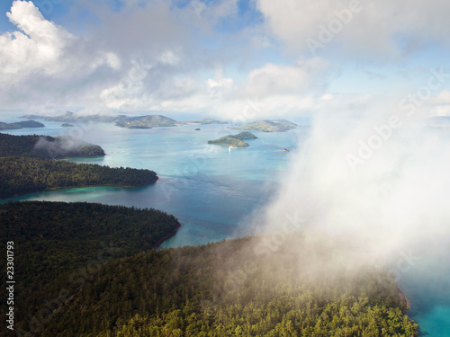Photo: Aerial view of the Whitsunday Islands through misty clouds Aerial view of the Whitsunday Islands through misty clouds