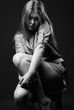 Black and white shot of girl sitting on chair Black and white shot of girl sitting on chair
