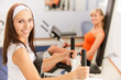 Two beautiful sportwomen make exercise