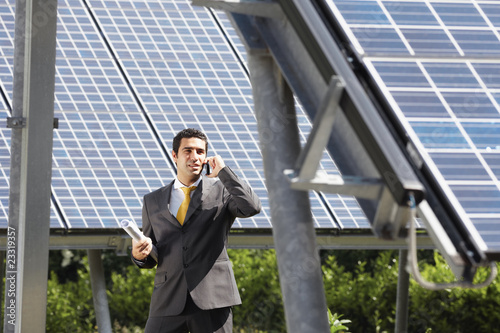 Photo: businessman and solar panels businessman and solar panels