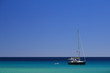 Photo: Sailboat on a clear blue sea under a cloudless blue sky Sailboat on a clear blue sea under a cloudless blue sky