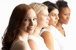 Portrait Of Four Attractive Young Women In Studio Standing In Li
