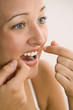 Woman Flossing Teeth
