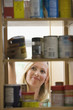 Woman Looking in Kitchen Cupboards